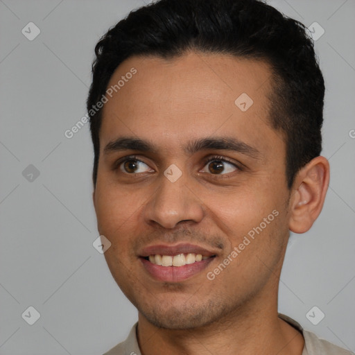 Joyful latino young-adult male with short  black hair and brown eyes