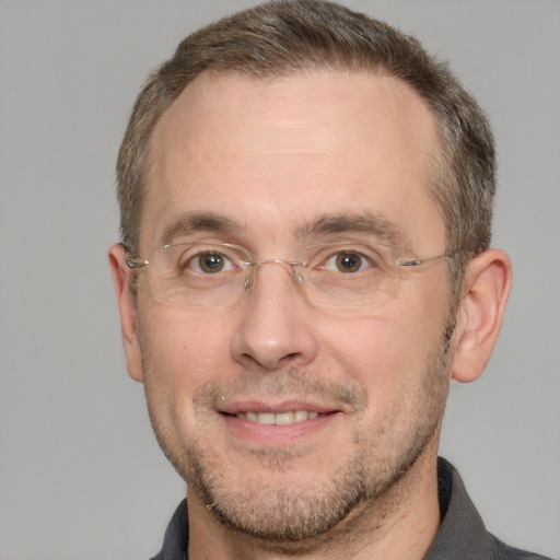 Joyful white adult male with short  brown hair and brown eyes