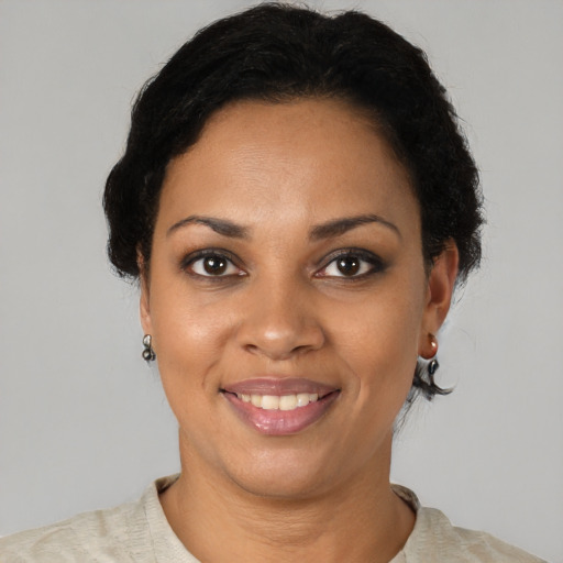 Joyful black young-adult female with short  black hair and brown eyes