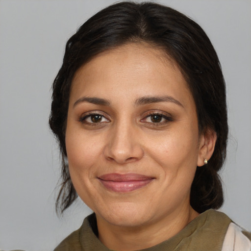 Joyful white adult female with medium  brown hair and brown eyes