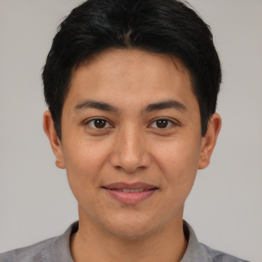 Joyful latino young-adult male with short  black hair and brown eyes