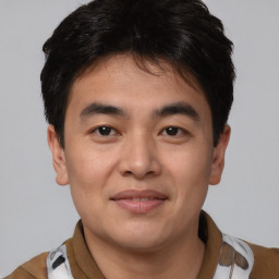 Joyful asian young-adult male with short  brown hair and brown eyes