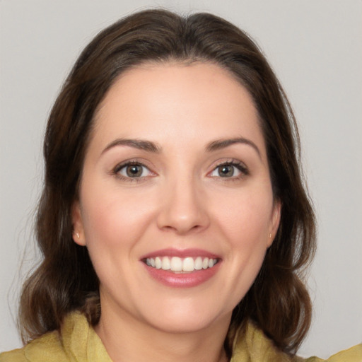 Joyful white young-adult female with medium  brown hair and brown eyes