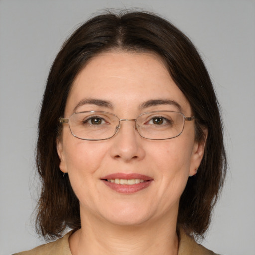 Joyful white adult female with medium  brown hair and brown eyes