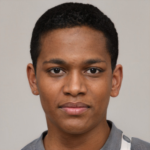 Joyful black young-adult male with short  black hair and brown eyes