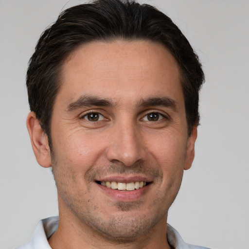 Joyful white young-adult male with short  brown hair and brown eyes