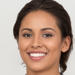 Joyful white young-adult female with long  brown hair and brown eyes