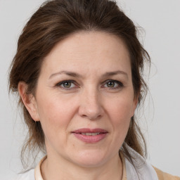 Joyful white adult female with medium  brown hair and grey eyes