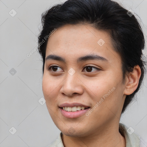 Joyful asian young-adult female with short  brown hair and brown eyes