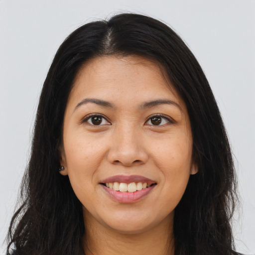 Joyful asian young-adult female with long  brown hair and brown eyes