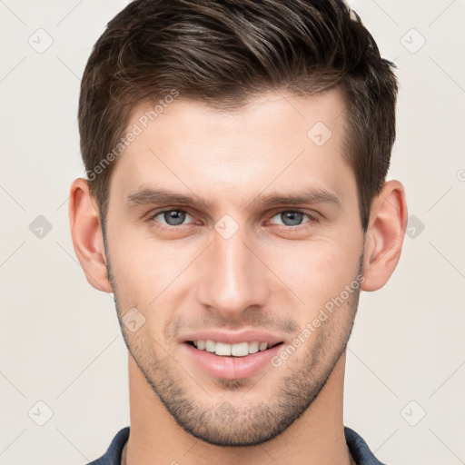 Joyful white young-adult male with short  brown hair and grey eyes