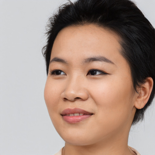 Joyful asian young-adult female with medium  black hair and brown eyes