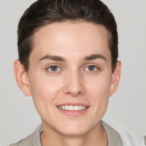 Joyful white young-adult female with short  brown hair and grey eyes