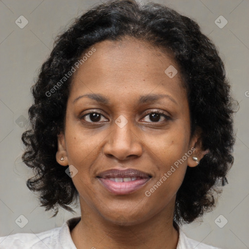 Joyful black adult female with medium  brown hair and brown eyes