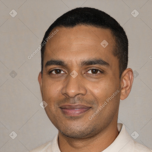 Joyful black young-adult male with short  black hair and brown eyes