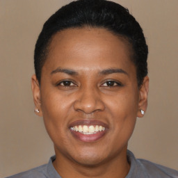 Joyful black young-adult female with short  black hair and brown eyes