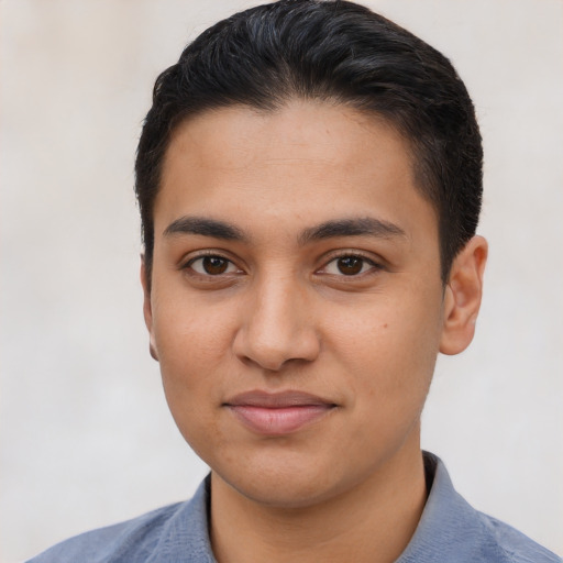 Joyful latino young-adult male with short  brown hair and brown eyes