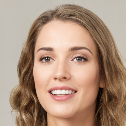 Joyful white young-adult female with long  brown hair and green eyes