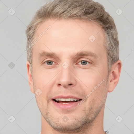 Joyful white adult male with short  brown hair and brown eyes