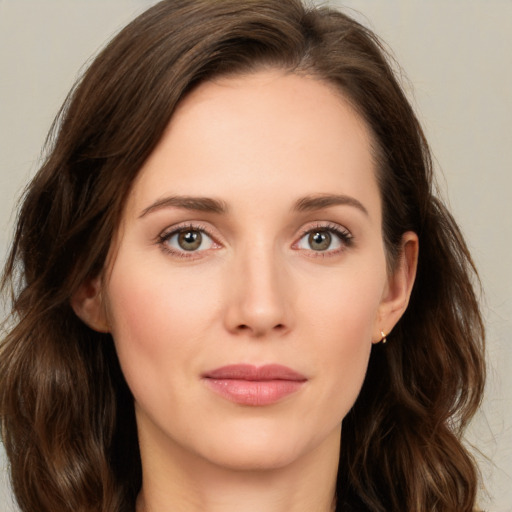 Joyful white young-adult female with long  brown hair and green eyes