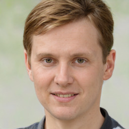 Joyful white adult male with short  brown hair and grey eyes