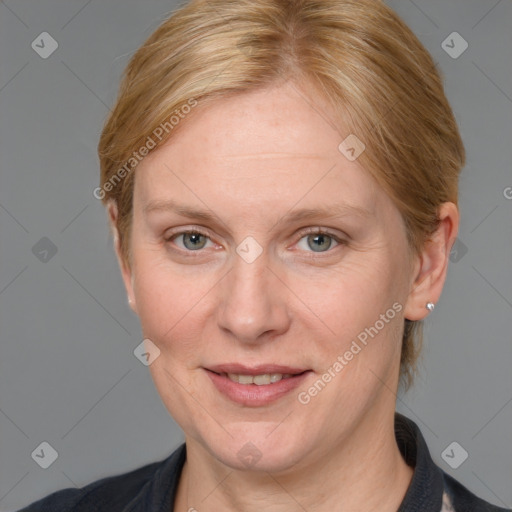 Joyful white adult female with medium  brown hair and blue eyes