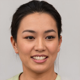 Joyful asian young-adult female with medium  brown hair and brown eyes