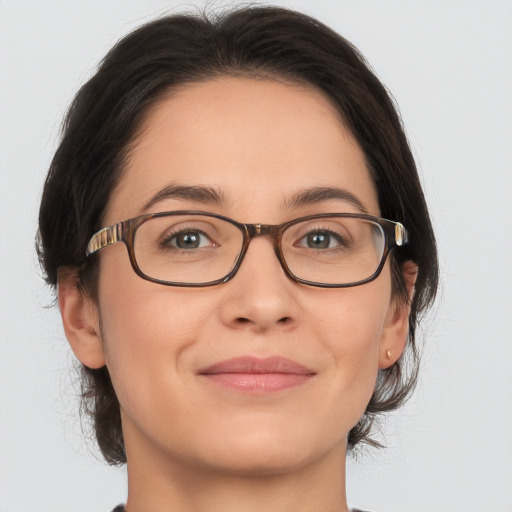 Joyful white adult female with medium  brown hair and brown eyes