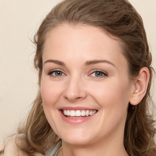 Joyful white young-adult female with long  brown hair and grey eyes