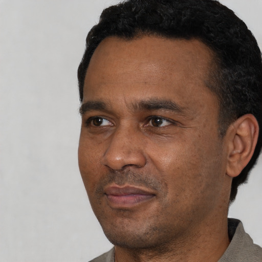 Neutral latino adult male with short  black hair and brown eyes