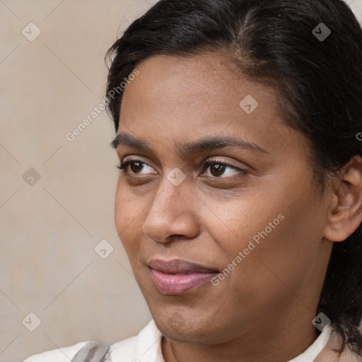 Joyful latino young-adult female with medium  brown hair and brown eyes