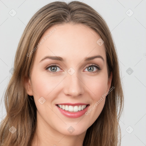 Joyful white young-adult female with long  brown hair and green eyes