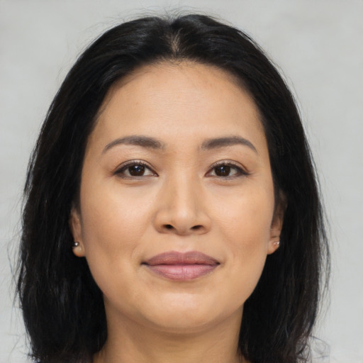 Joyful asian young-adult female with long  brown hair and brown eyes