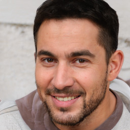 Joyful white adult male with short  brown hair and brown eyes