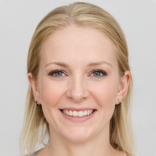 Joyful white young-adult female with long  brown hair and blue eyes