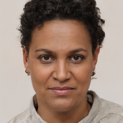 Joyful black adult female with short  brown hair and brown eyes
