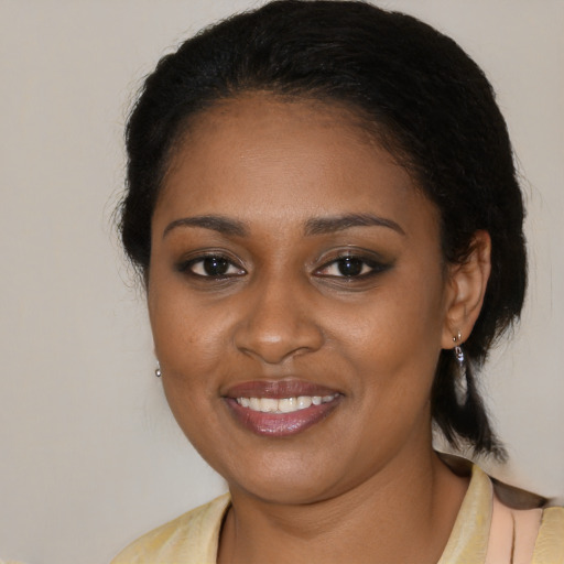 Joyful black young-adult female with medium  black hair and brown eyes