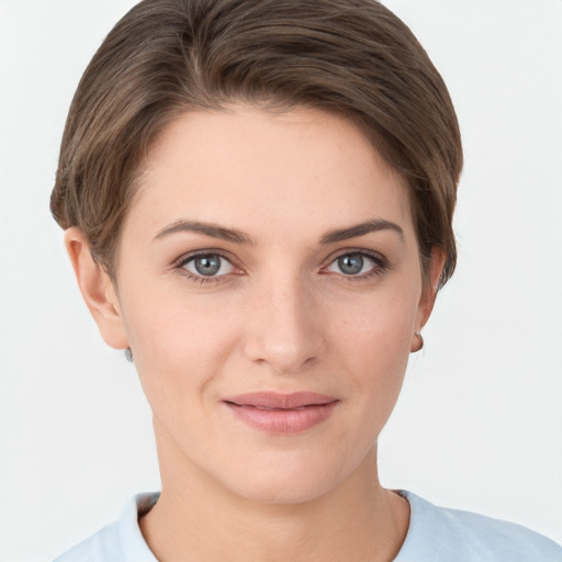 Joyful white young-adult female with short  brown hair and grey eyes