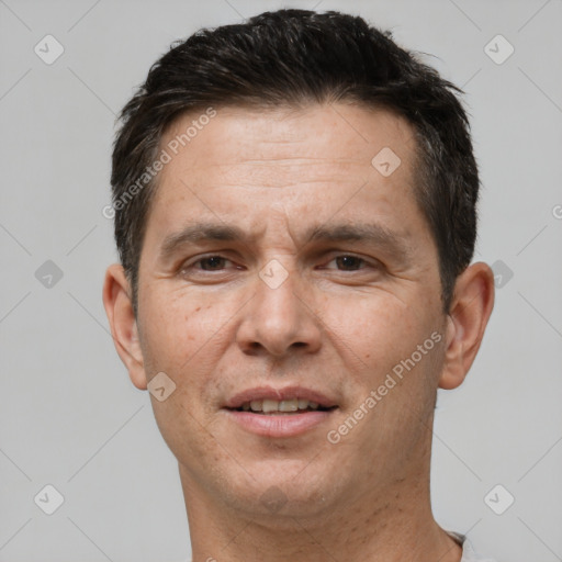 Joyful white adult male with short  brown hair and brown eyes