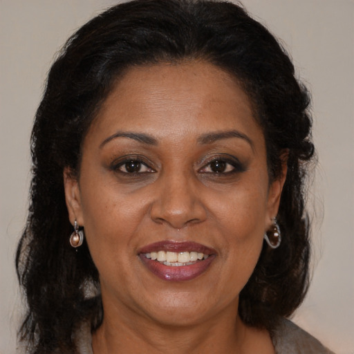 Joyful black adult female with medium  brown hair and brown eyes