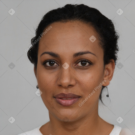 Joyful black young-adult female with short  black hair and brown eyes