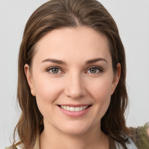 Joyful white young-adult female with medium  brown hair and grey eyes