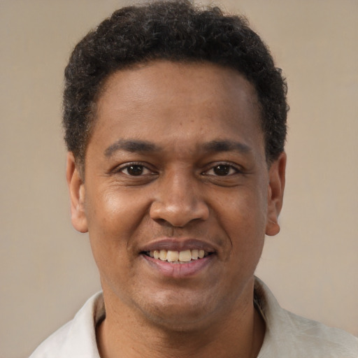 Joyful latino adult male with short  brown hair and brown eyes