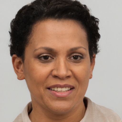 Joyful latino adult female with short  brown hair and brown eyes