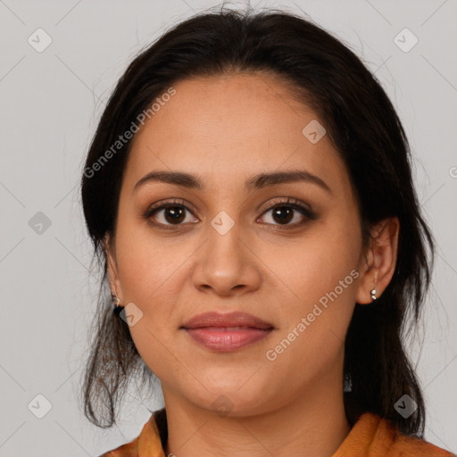 Joyful latino young-adult female with medium  brown hair and brown eyes