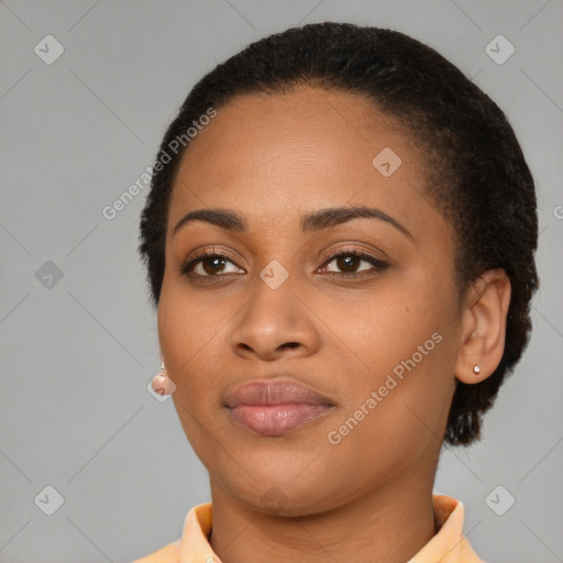 Joyful black young-adult female with short  brown hair and brown eyes