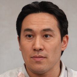 Neutral asian adult male with short  black hair and brown eyes