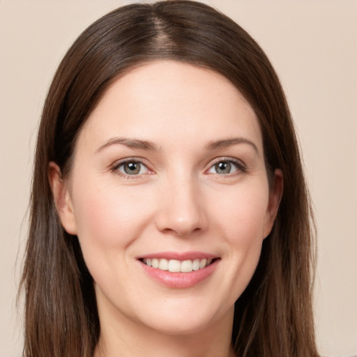 Joyful white young-adult female with long  brown hair and brown eyes