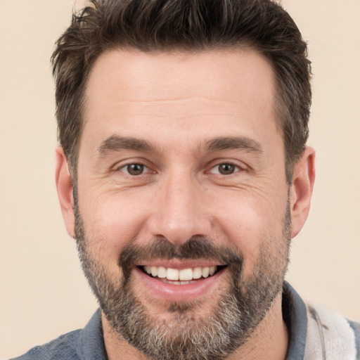 Joyful white adult male with short  brown hair and brown eyes