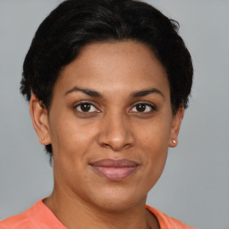 Joyful black adult female with short  brown hair and brown eyes